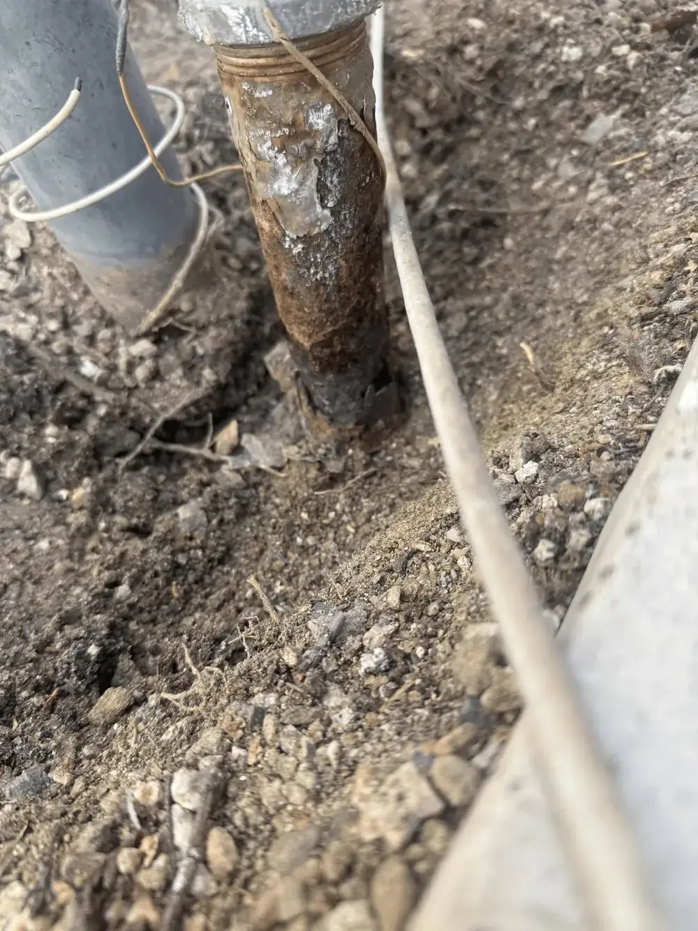 Close-up of severely corroded galvanized gas pipe