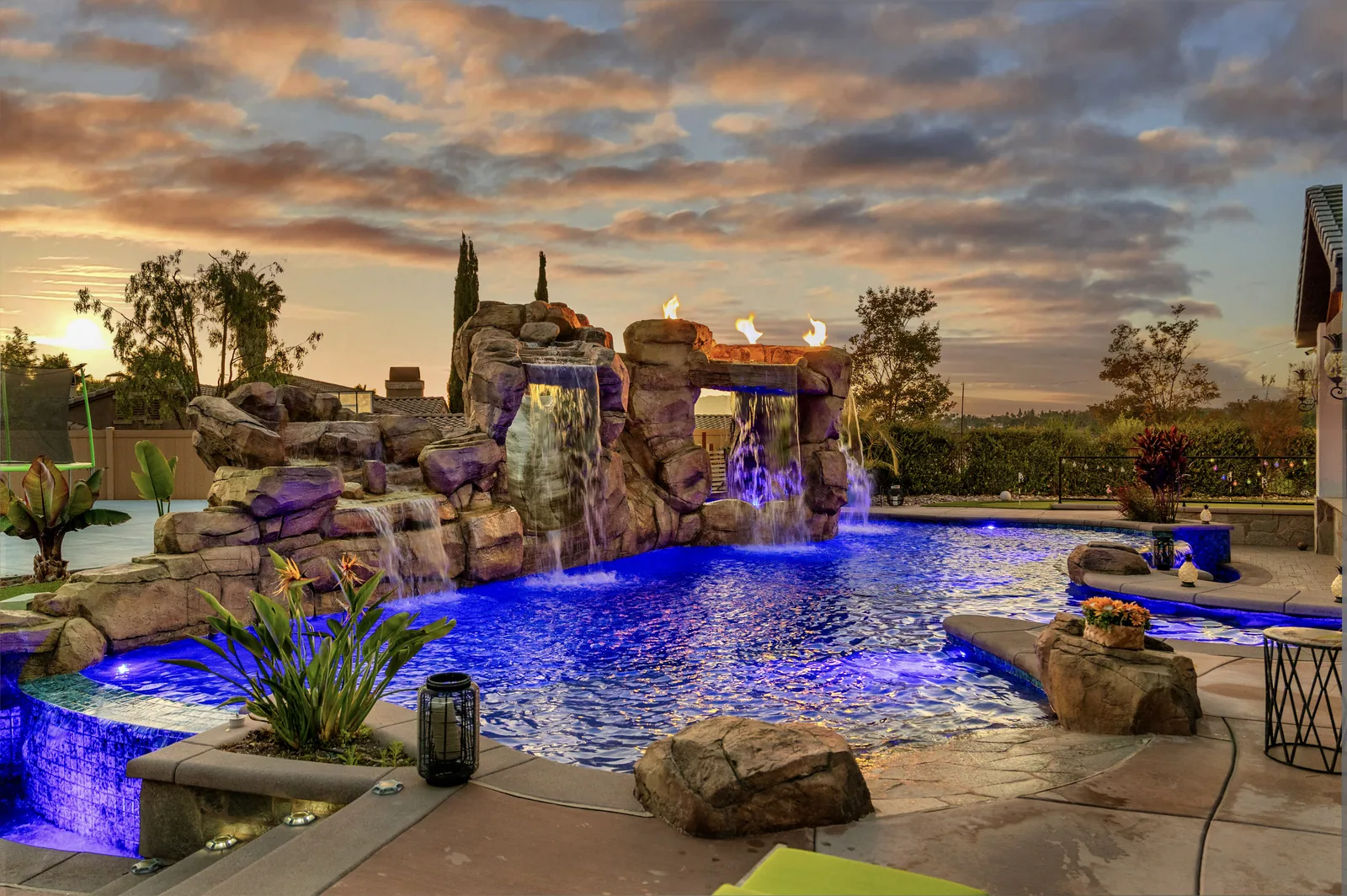 Luxury pool with fire features — serviced by No Excuses Pool Service